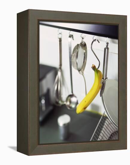 Banana and Kitchen Tools Hanging on Hooks in Kitchen-Kröger & Gross-Framed Premier Image Canvas