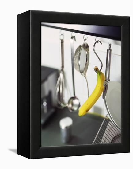 Banana and Kitchen Tools Hanging on Hooks in Kitchen-Kröger & Gross-Framed Premier Image Canvas