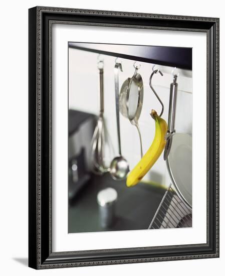 Banana and Kitchen Tools Hanging on Hooks in Kitchen-Kröger & Gross-Framed Photographic Print