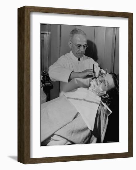 Barber Victor E. Aceto Shaving Passenger Aboard the 20th Century Limited-Alfred Eisenstaedt-Framed Photographic Print