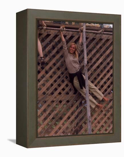 Barefoot Girl Swinging on Structure Containing Baby Chicks in Coop, Woodstock Music and Art Fair-John Dominis-Framed Premier Image Canvas