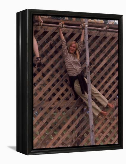 Barefoot Girl Swinging on Structure Containing Baby Chicks in Coop, Woodstock Music and Art Fair-John Dominis-Framed Premier Image Canvas