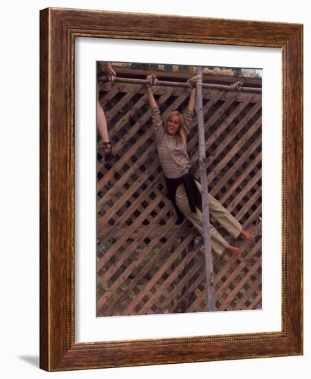 Barefoot Girl Swinging on Structure Containing Baby Chicks in Coop, Woodstock Music and Art Fair-John Dominis-Framed Photographic Print