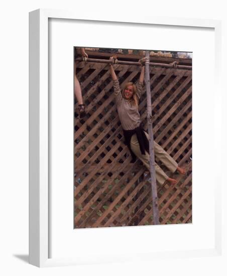 Barefoot Girl Swinging on Structure Containing Baby Chicks in Coop, Woodstock Music and Art Fair-John Dominis-Framed Photographic Print