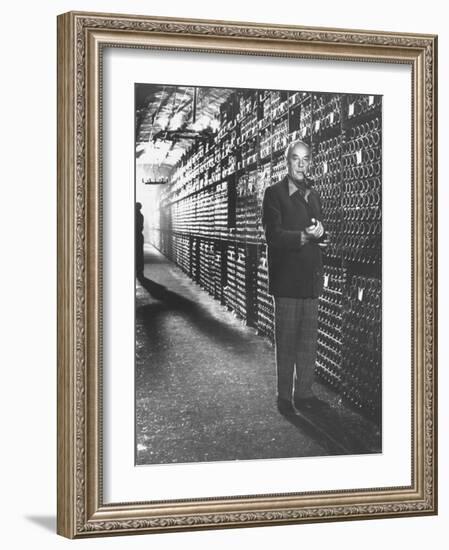 Baron Philippe De Rothschild in a Wine Cellar at Chateau Mouton Rothschild-Carlo Bavagnoli-Framed Photographic Print