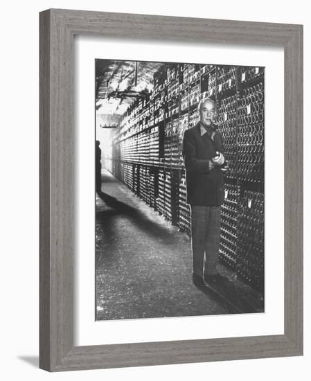 Baron Philippe De Rothschild in a Wine Cellar at Chateau Mouton Rothschild-Carlo Bavagnoli-Framed Photographic Print