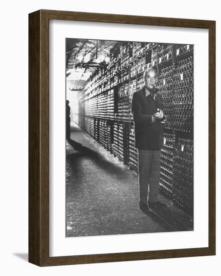 Baron Philippe De Rothschild in a Wine Cellar at Chateau Mouton Rothschild-Carlo Bavagnoli-Framed Photographic Print