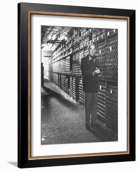 Baron Philippe De Rothschild in a Wine Cellar at Chateau Mouton Rothschild-Carlo Bavagnoli-Framed Photographic Print