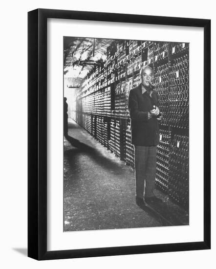 Baron Philippe De Rothschild in a Wine Cellar at Chateau Mouton Rothschild-Carlo Bavagnoli-Framed Photographic Print