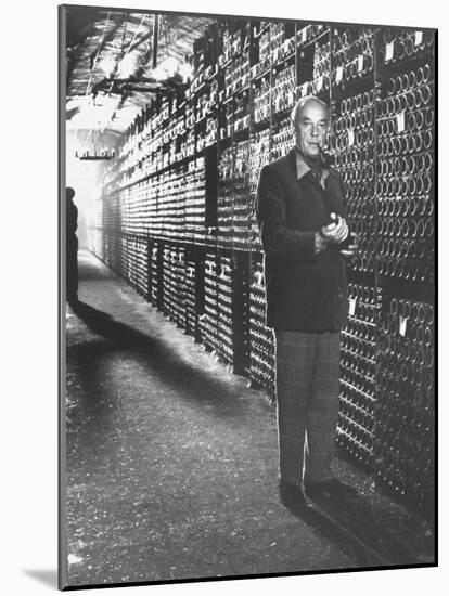 Baron Philippe De Rothschild in a Wine Cellar at Chateau Mouton Rothschild-Carlo Bavagnoli-Mounted Photographic Print