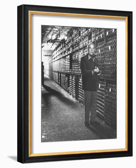 Baron Philippe De Rothschild in a Wine Cellar at Chateau Mouton Rothschild-Carlo Bavagnoli-Framed Photographic Print