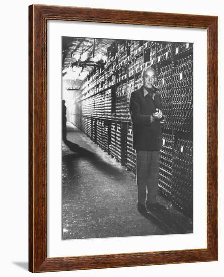 Baron Philippe De Rothschild in a Wine Cellar at Chateau Mouton Rothschild-Carlo Bavagnoli-Framed Photographic Print