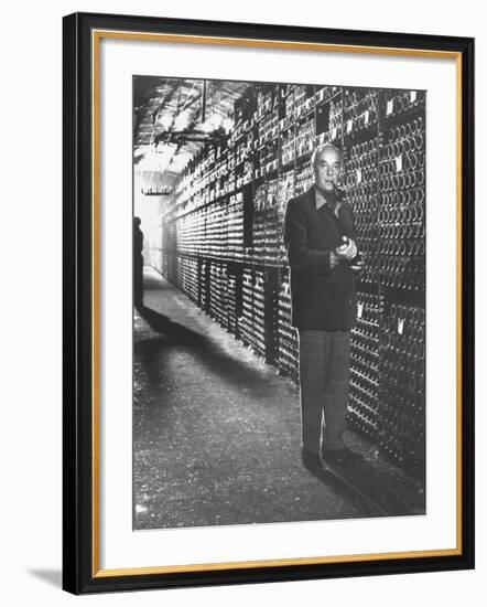 Baron Philippe De Rothschild in a Wine Cellar at Chateau Mouton Rothschild-Carlo Bavagnoli-Framed Photographic Print