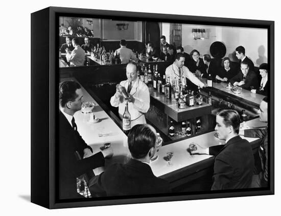 Bartender Prepares a Drink as Patrons Enjoy Themselves at Popular Speakeasy during Prohibition-Margaret Bourke-White-Framed Premier Image Canvas