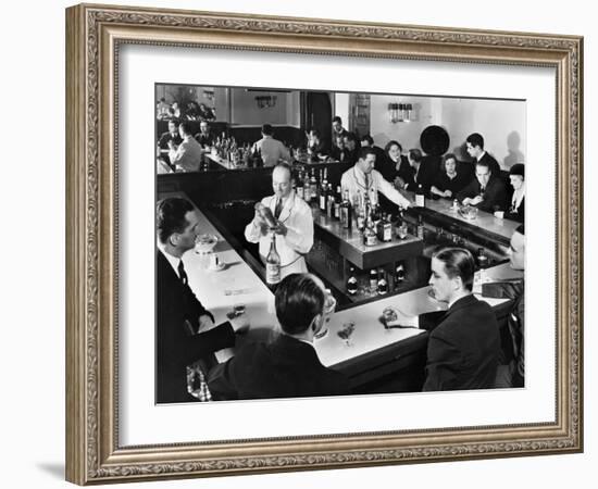 Bartender Prepares a Drink as Patrons Enjoy Themselves at Popular Speakeasy during Prohibition-Margaret Bourke-White-Framed Photographic Print