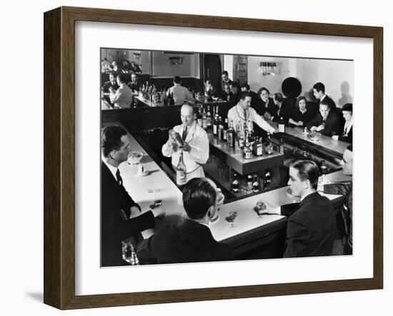 Bartender Prepares a Drink as Patrons Enjoy Themselves at Popular Speakeasy during Prohibition-Margaret Bourke-White-Framed Photographic Print