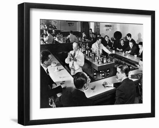 Bartender Prepares a Drink as Patrons Enjoy Themselves at Popular Speakeasy during Prohibition-Margaret Bourke-White-Framed Photographic Print