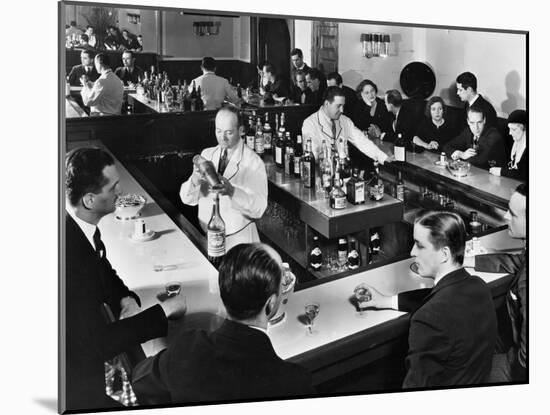 Bartender Prepares a Drink as Patrons Enjoy Themselves at Popular Speakeasy during Prohibition-Margaret Bourke-White-Mounted Photographic Print