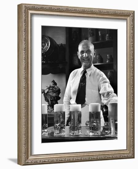 Bartender Smiling as He Serves Large Glasses of Beer-Frank Scherschel-Framed Photographic Print