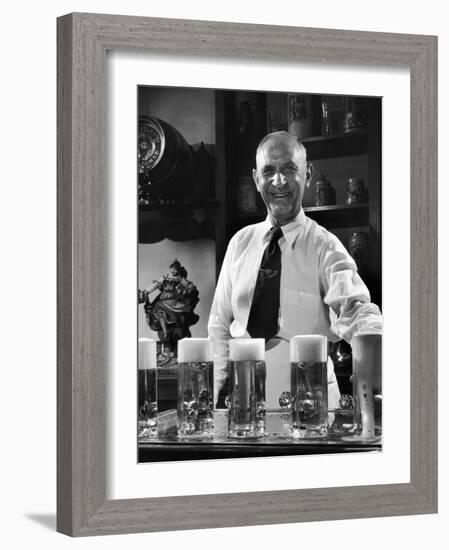 Bartender Smiling as He Serves Large Glasses of Beer-Frank Scherschel-Framed Photographic Print