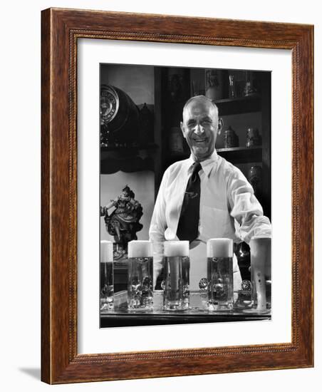 Bartender Smiling as He Serves Large Glasses of Beer-Frank Scherschel-Framed Photographic Print