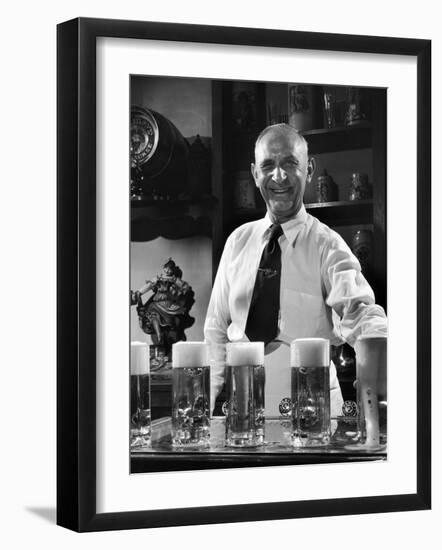 Bartender Smiling as He Serves Large Glasses of Beer-Frank Scherschel-Framed Photographic Print