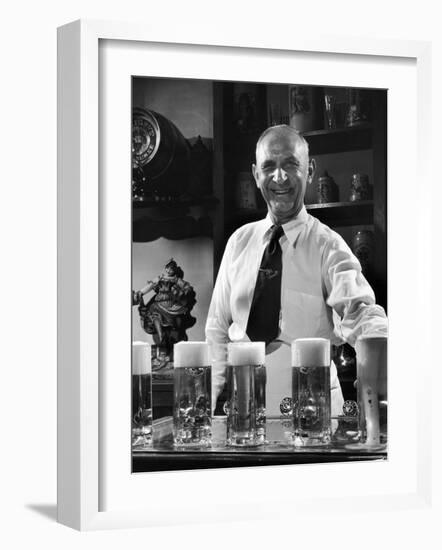 Bartender Smiling as He Serves Large Glasses of Beer-Frank Scherschel-Framed Photographic Print