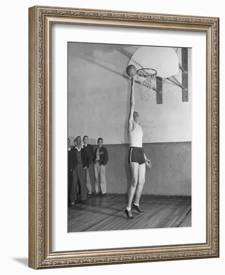 Basketball Player Max Palmer Reaching Up to Drop Basketball into Basket-null-Framed Photographic Print