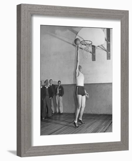 Basketball Player Max Palmer Reaching Up to Drop Basketball into Basket-null-Framed Photographic Print