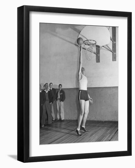 Basketball Player Max Palmer Reaching Up to Drop Basketball into Basket-null-Framed Photographic Print