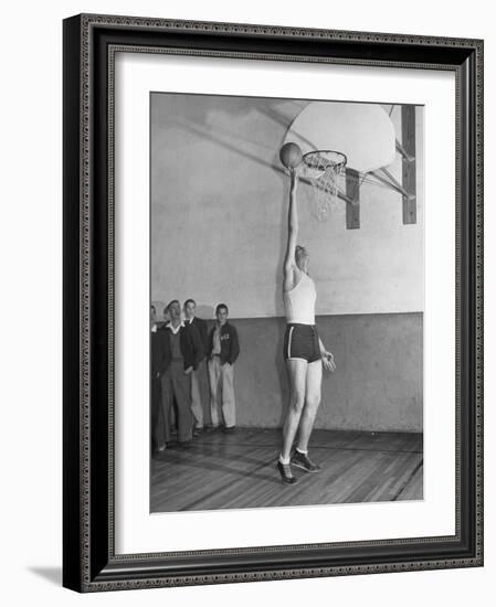 Basketball Player Max Palmer Reaching Up to Drop Basketball into Basket-null-Framed Photographic Print