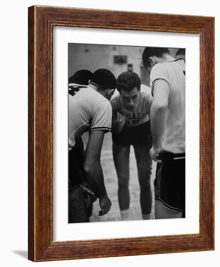 Basketball Player Tom Gola in a Huddle During a Basketball Game-null-Framed Photographic Print