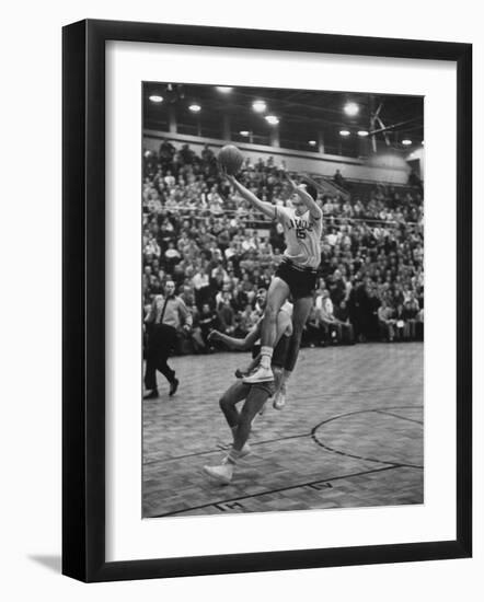 Basketball Player Tom Gola Leaping in the Air to Make a Shot During a Basketball Game-null-Framed Photographic Print