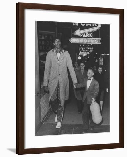 Basketball Player Wilt Chamberlain Walking with an Unidentified Child-null-Framed Premium Photographic Print