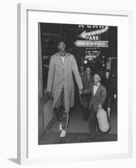 Basketball Player Wilt Chamberlain Walking with an Unidentified Child-null-Framed Premium Photographic Print