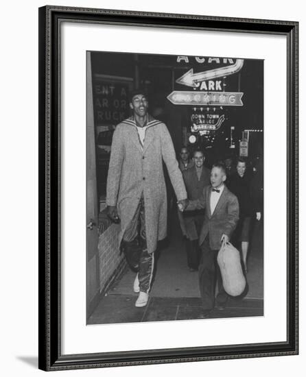 Basketball Player Wilt Chamberlain Walking with an Unidentified Child-null-Framed Premium Photographic Print