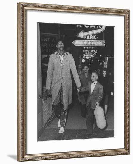 Basketball Player Wilt Chamberlain Walking with an Unidentified Child-null-Framed Premium Photographic Print