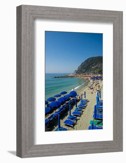 Beach umbrellas lining the beach in Monterosso al Mare, Cinque Terre, Italy.-Michael DeFreitas-Framed Photographic Print