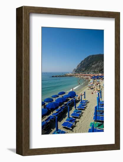 Beach umbrellas lining the beach in Monterosso al Mare, Cinque Terre, Italy.-Michael DeFreitas-Framed Photographic Print