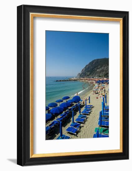 Beach umbrellas lining the beach in Monterosso al Mare, Cinque Terre, Italy.-Michael DeFreitas-Framed Photographic Print