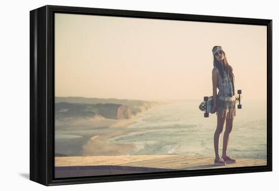 Beautiful And Fashion Young Woman Posing With A Skateboard-iko-Framed Stretched Canvas