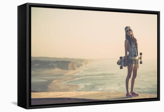 Beautiful And Fashion Young Woman Posing With A Skateboard-iko-Framed Stretched Canvas