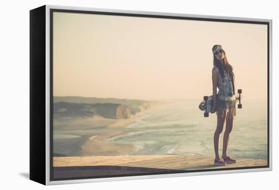 Beautiful And Fashion Young Woman Posing With A Skateboard-iko-Framed Stretched Canvas