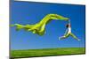 Beautiful Young Woman Jumping On A Green Meadow With A Colored Tissue-iko-Mounted Photographic Print