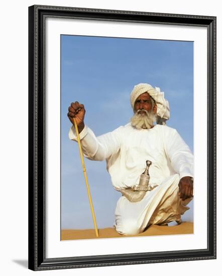 Bedouin Man Kneels on Top of a Sand Dune in the Desert-John Warburton-lee-Framed Photographic Print