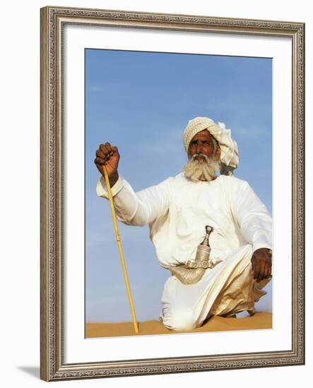 Bedouin Man Kneels on Top of a Sand Dune in the Desert-John Warburton-lee-Framed Photographic Print