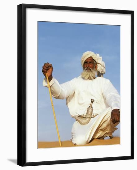 Bedouin Man Kneels on Top of a Sand Dune in the Desert-John Warburton-lee-Framed Photographic Print