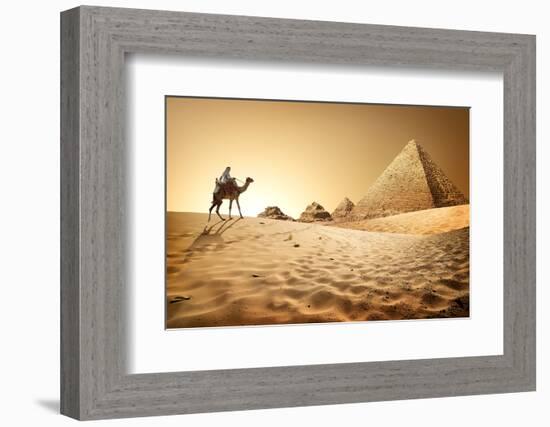 Bedouin on Camel near Pyramids in Desert-Givaga-Framed Photographic Print