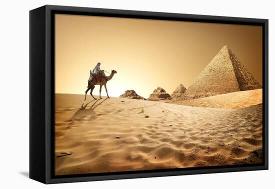 Bedouin on Camel near Pyramids in Desert-Givaga-Framed Premier Image Canvas