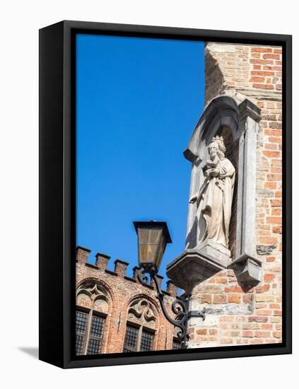 Belgium, Brugge. A stone statue on the cornerstone of a building.-Julie Eggers-Framed Premier Image Canvas